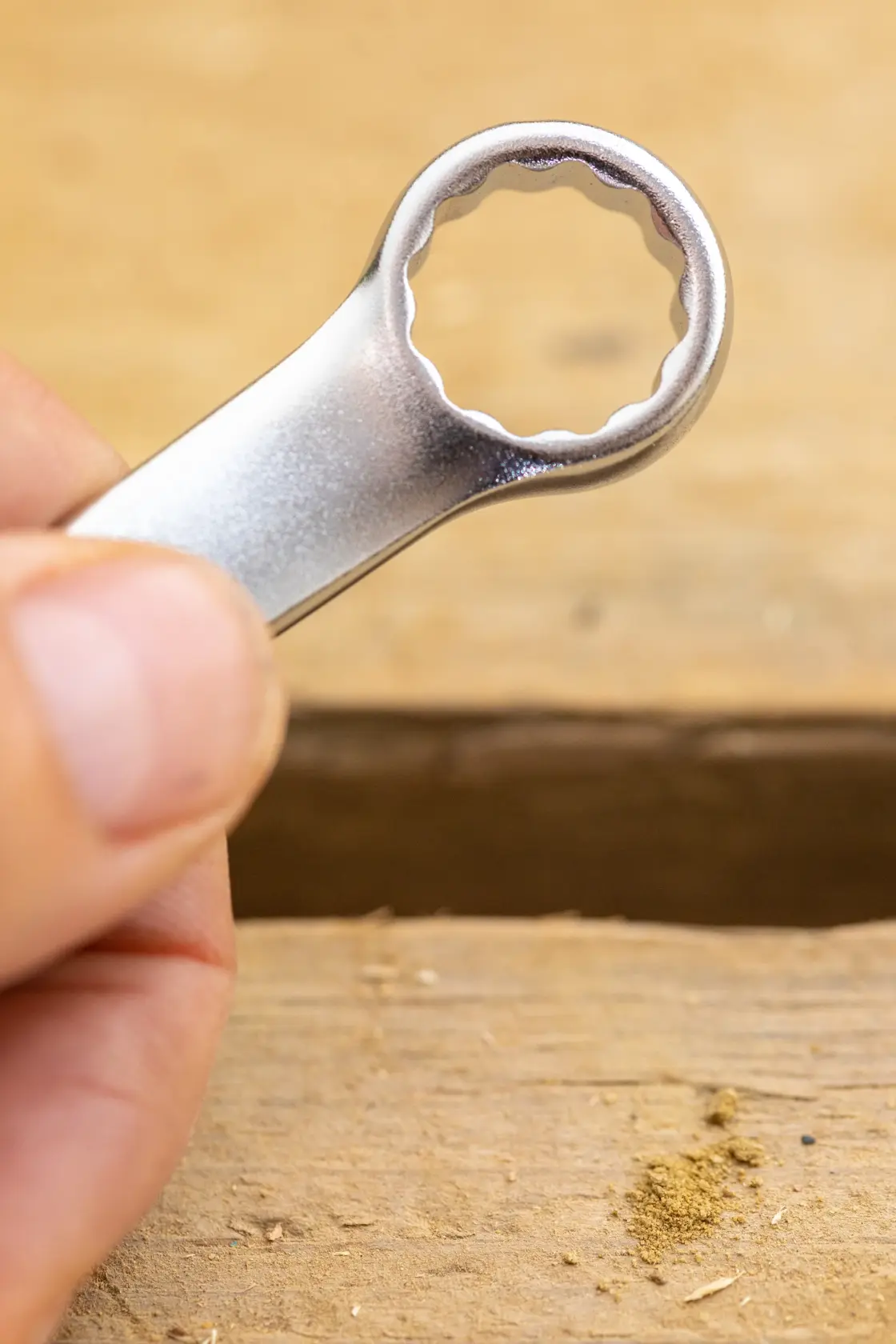 STANLEY FMMT13033-0 box-end wrench close-up held by hand, silver finish, photography category.