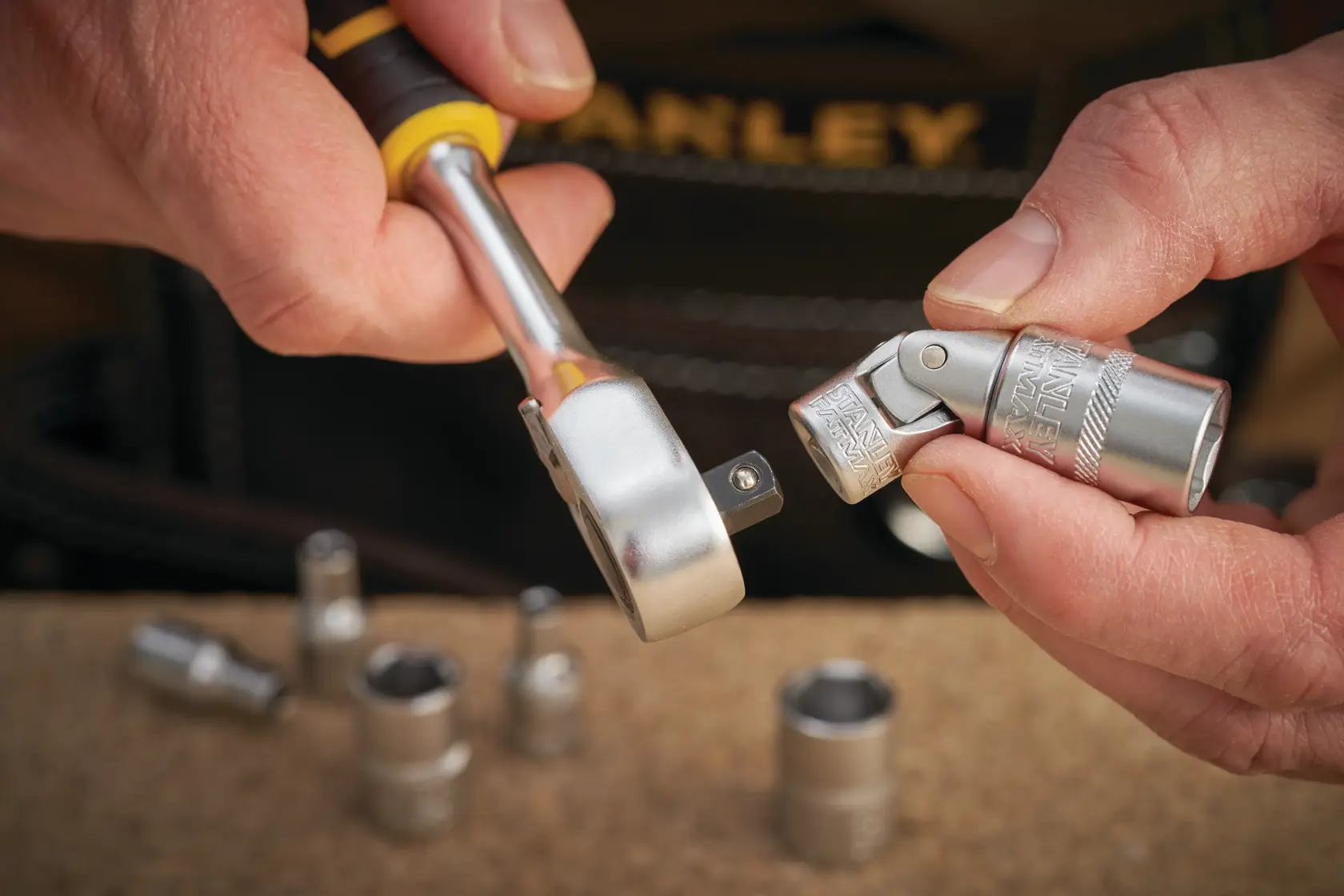 STANLEY FMMT18008-0 socket wrench and universal joint close-up, photography of hand holding tool.