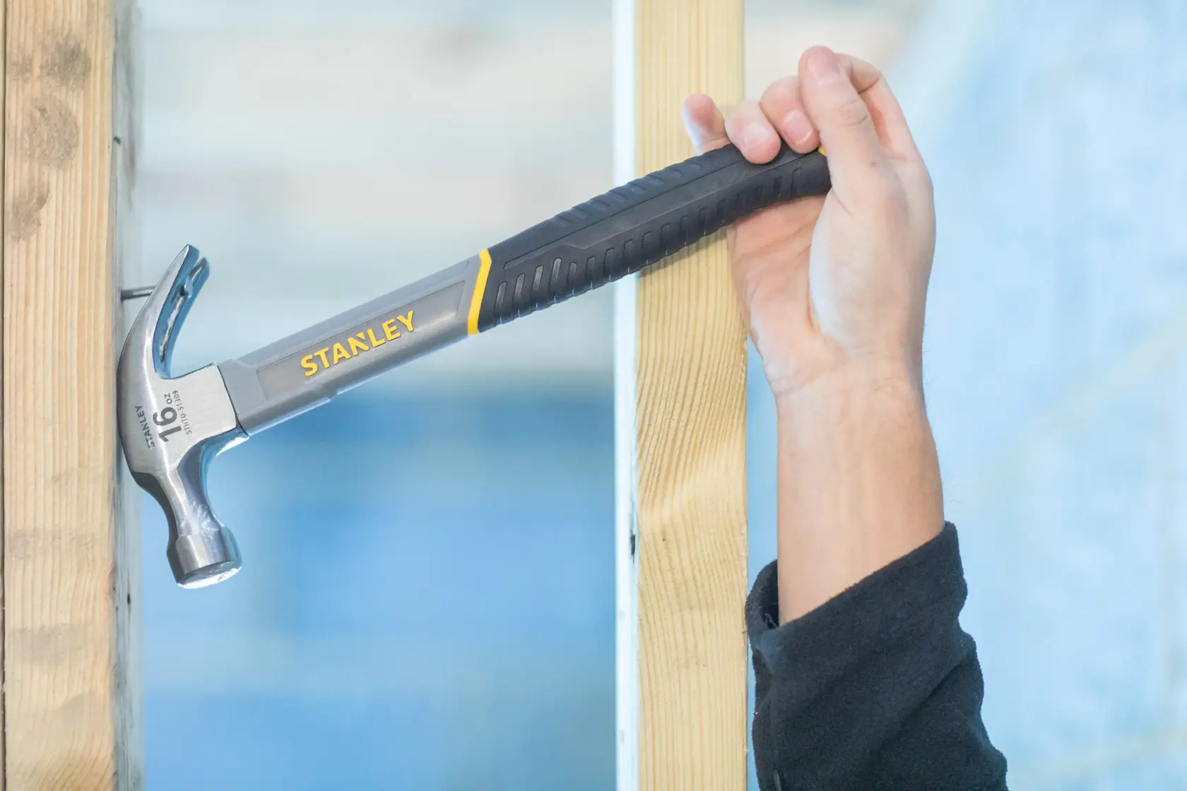 STANLEY STHT0-51310 claw hammer with black and yellow grip, side view on white background.
