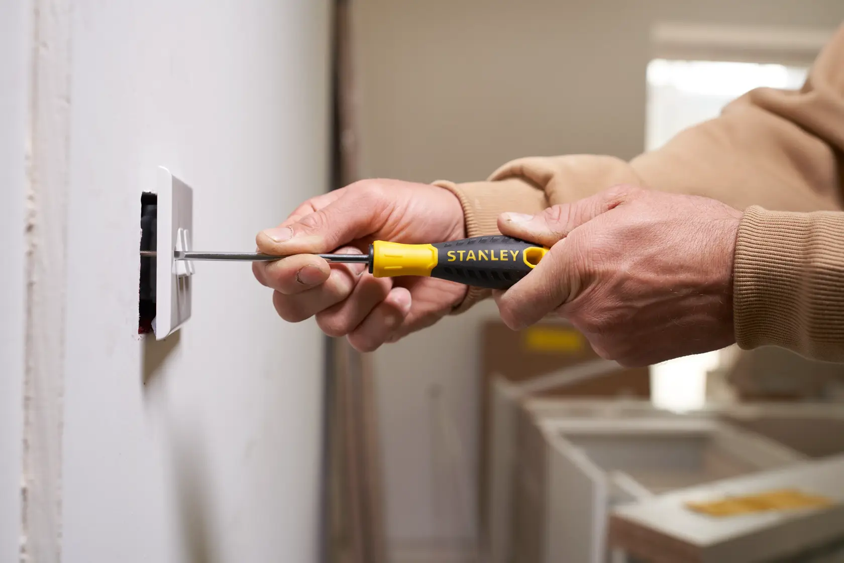 Photo of STANLEY STHT0-60358 screwdriver, yellow and black handle, used to install wall outlet.