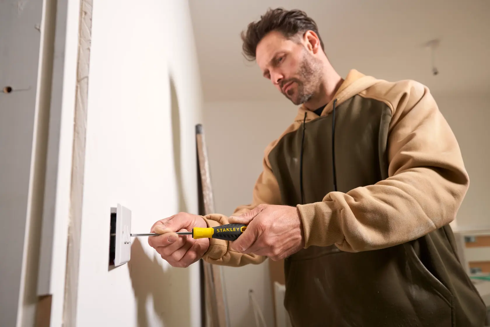 Photo of STANLEY STHT0-60358 screwdriver in use to install an electrical outlet.