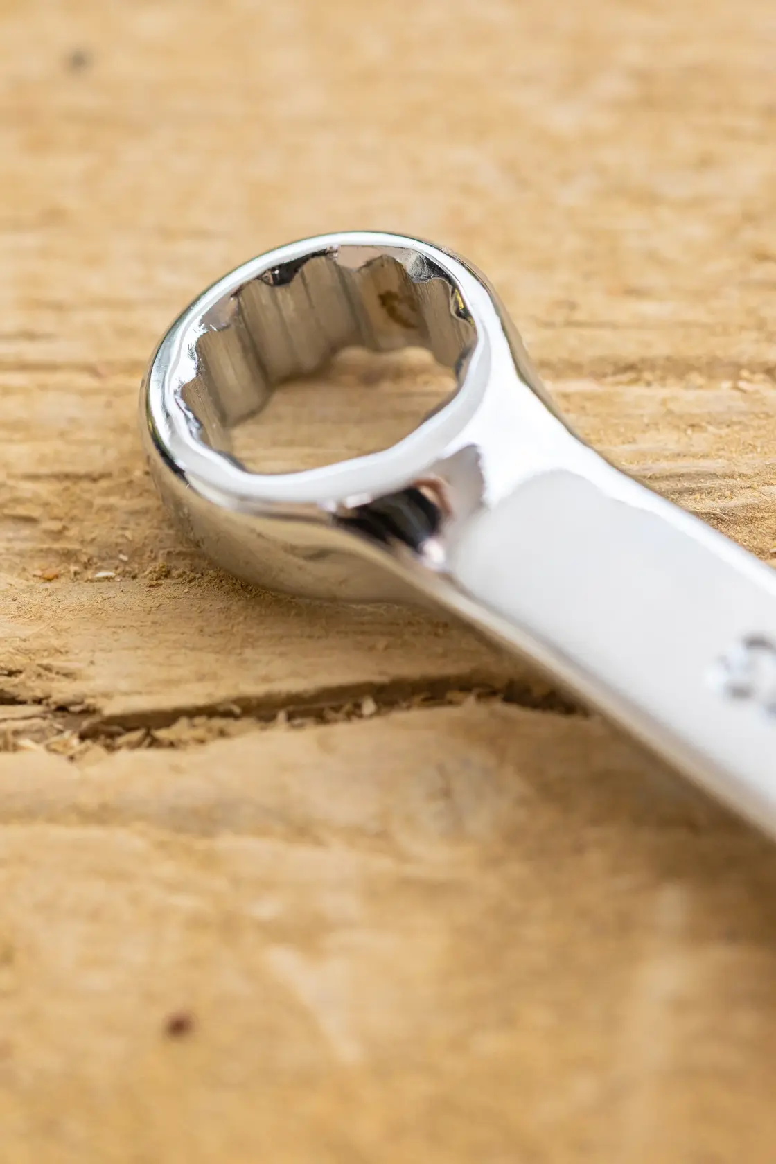 STANLEY STMT95908-0 close-up of chrome box-end wrench on wood surface, product photography.
